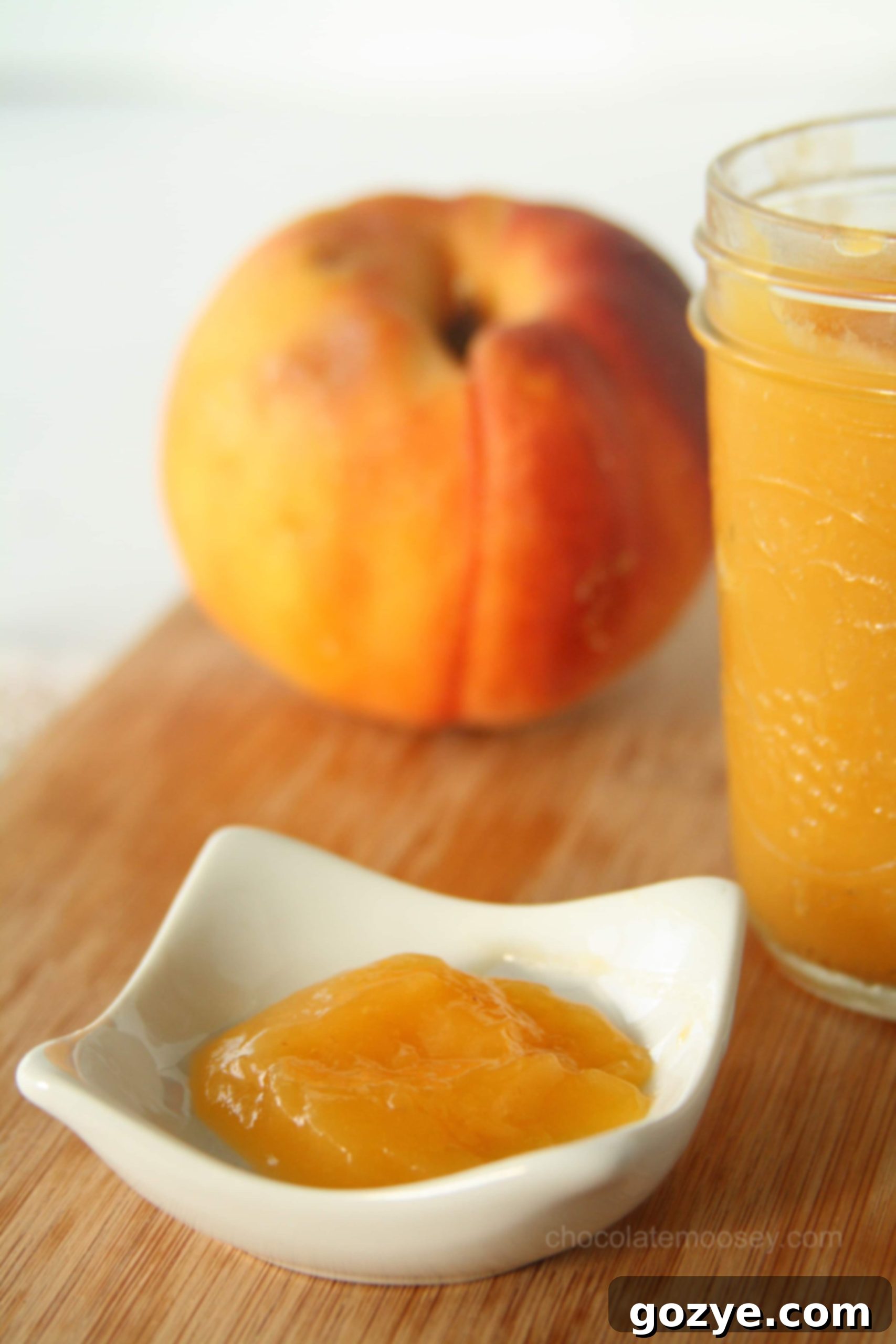 Close-up of smooth peach curd in a white bowl