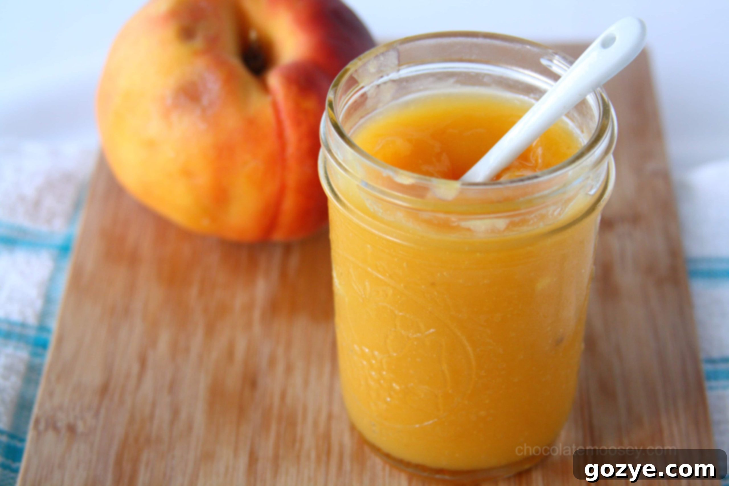 Beautiful jar of homemade peach curd, gleaming in the light