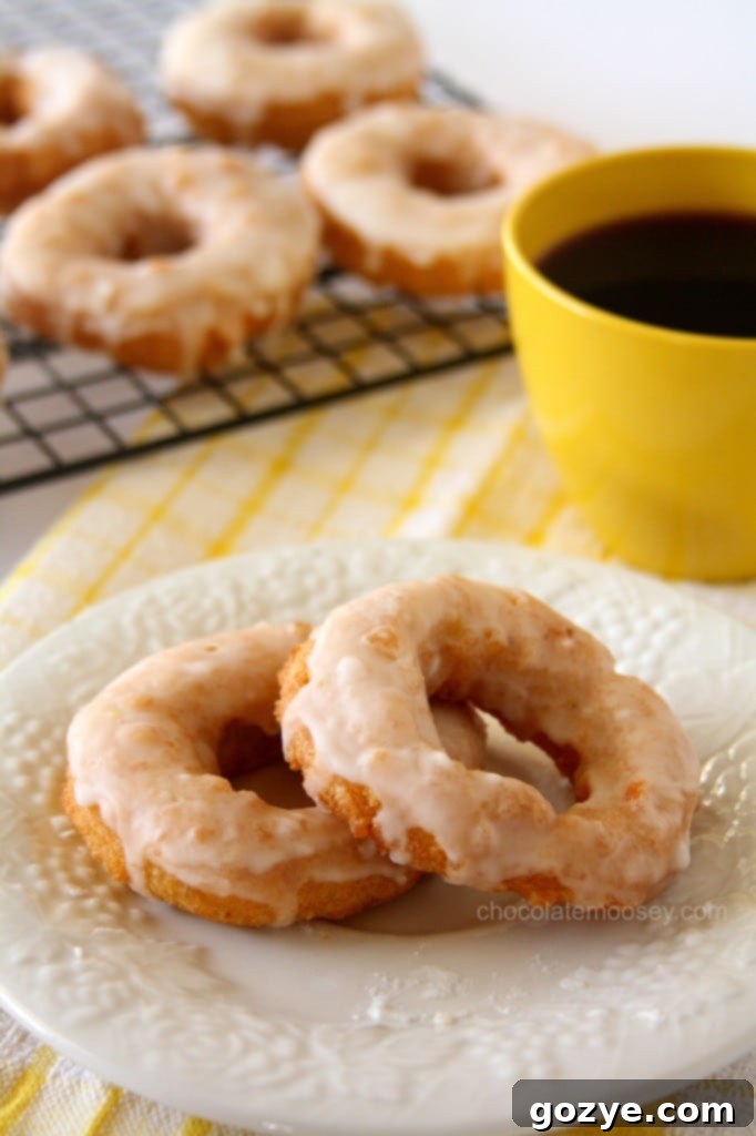 Double Lemon Glazed Doughnuts from www.chocolatemoosey.com Double Lemon Glazed Doughnuts with a prominent white glaze