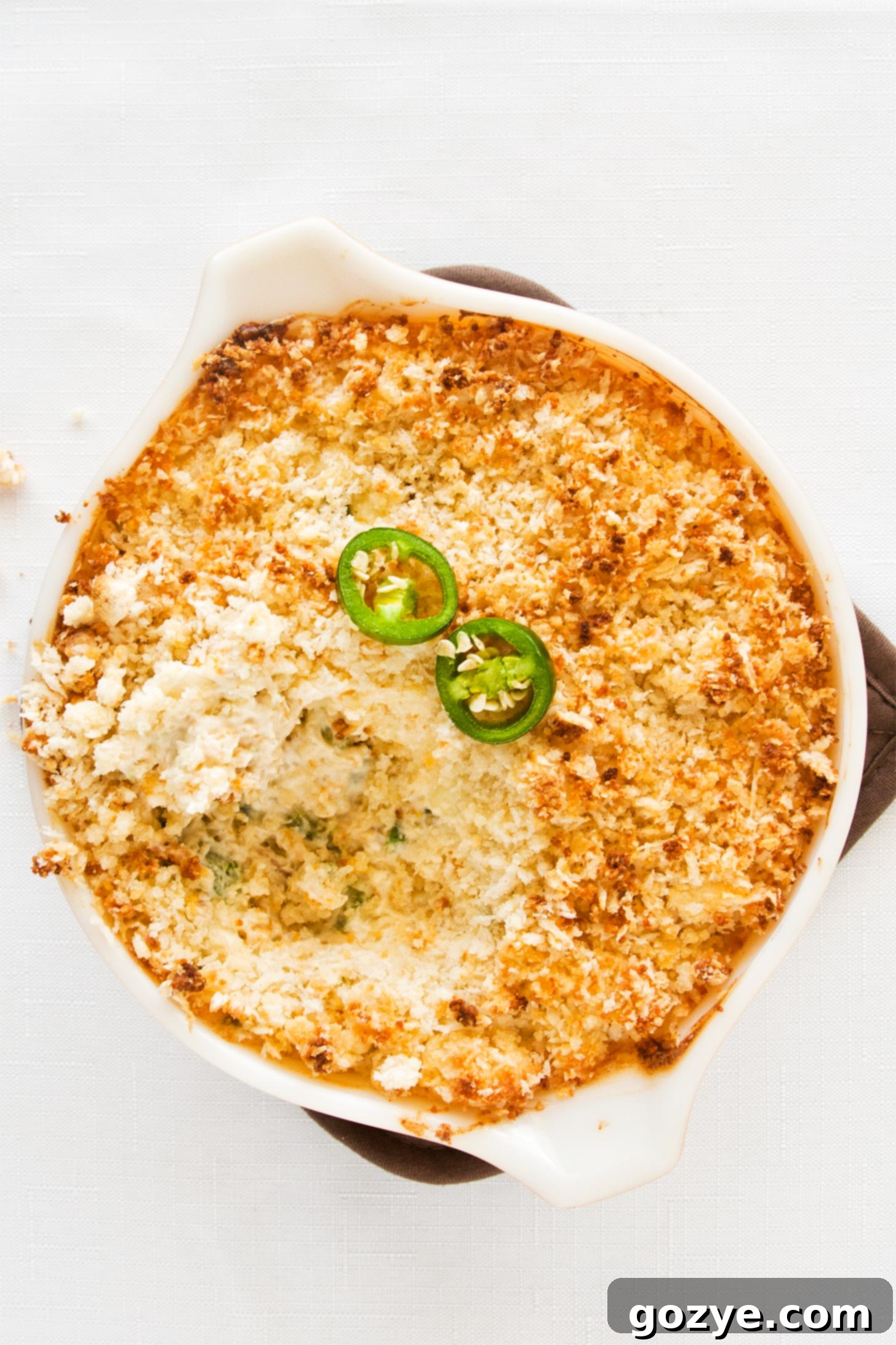 Jalapeno Pepper Popper Dip with some dip eaten already, showing the creamy texture.