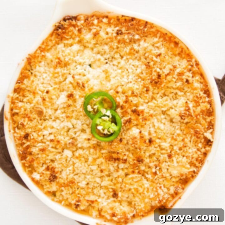 Jalapeno popper dip in casserole dish, topped with crispy breadcrumbs.