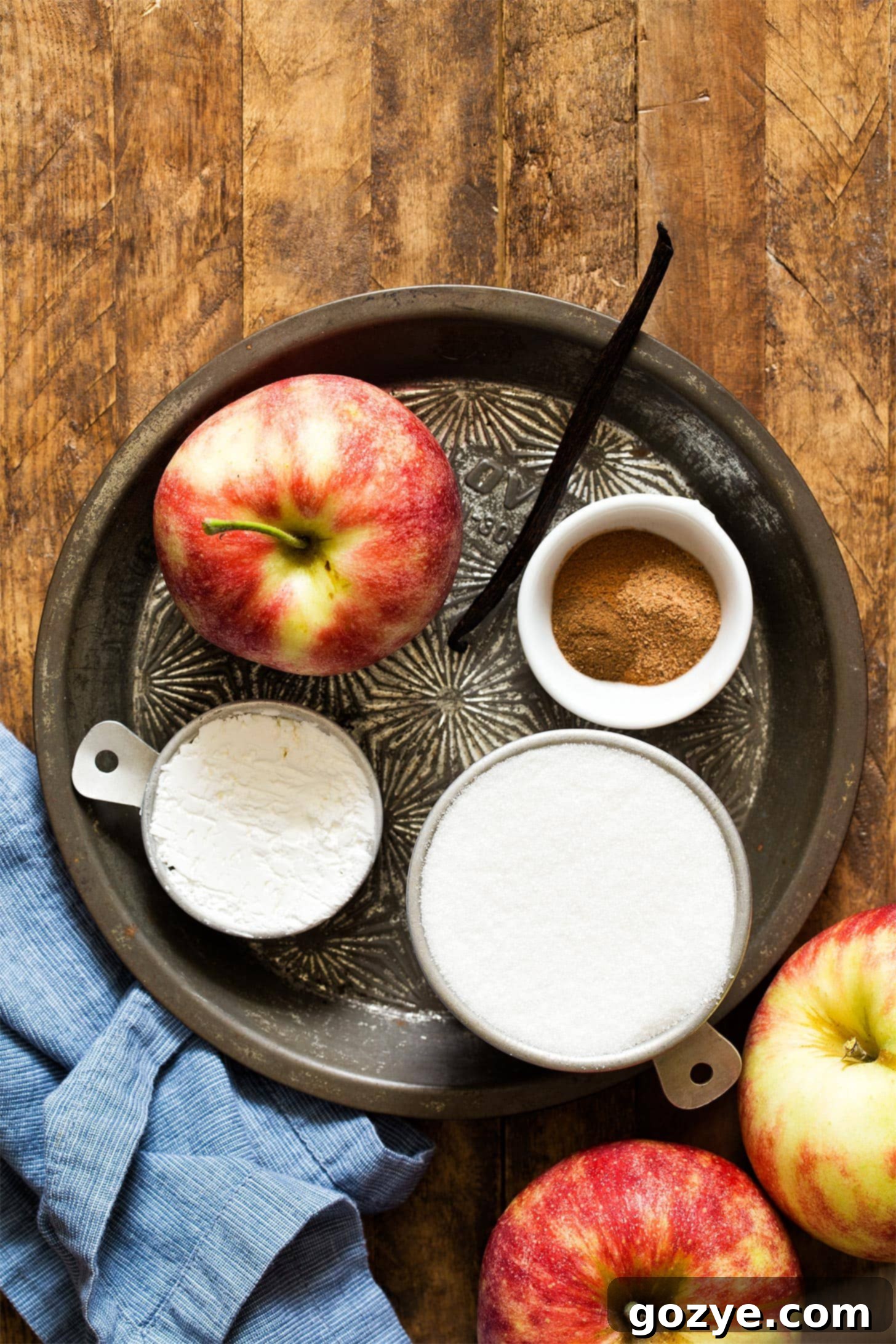 Ingredients for apple pie filling on a pie plate
