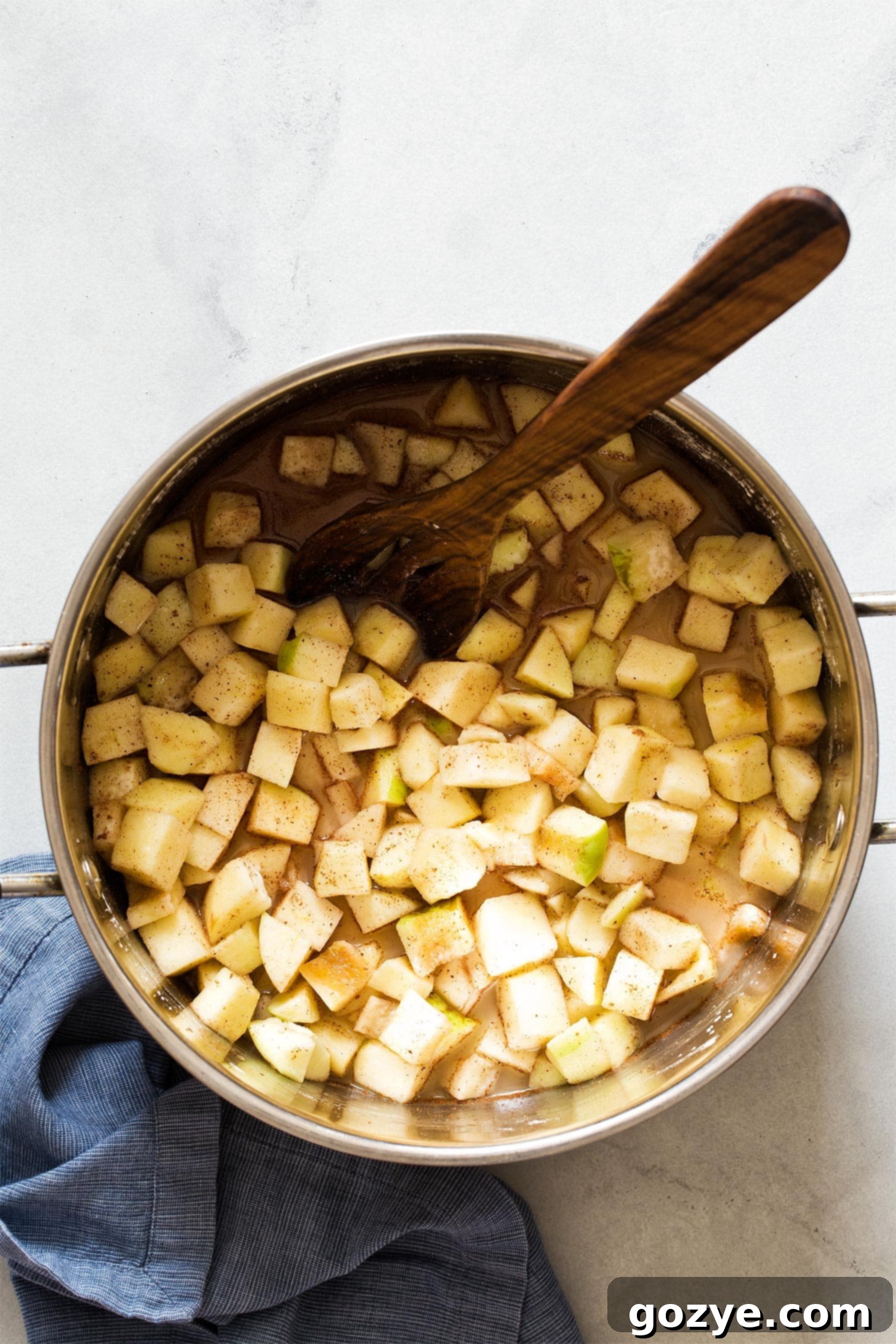 Apples tossed with sugar and spices in a large pot