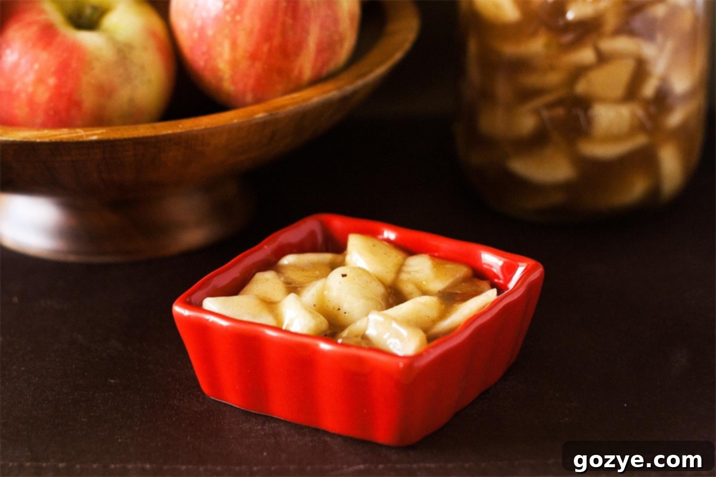 Homemade apple pie filling recipe in a red bowl