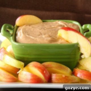 Dippable Caramel Apple Cheesecake 6 Creamy Caramel Apple Cheesecake Dip in a green bowl with dippers