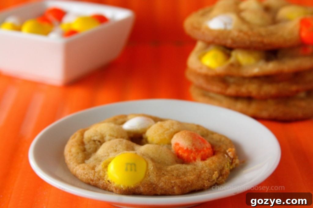 A plate of homemade White Chocolate Candy Corn M&M Cookies.