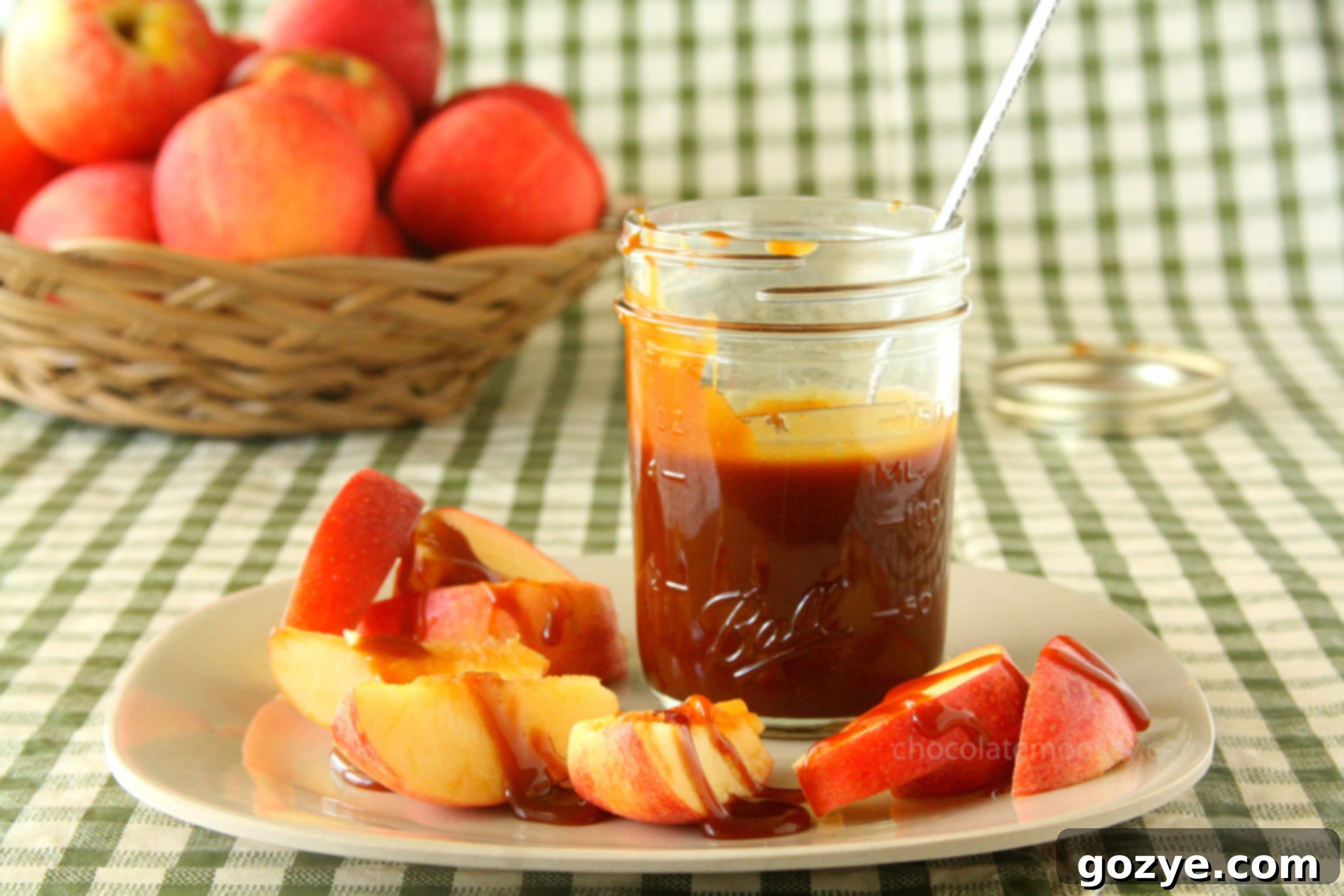 Jar of caramel sauce with apple slices