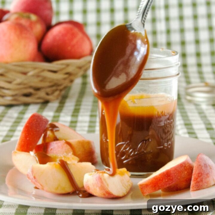 Caramel sauce dripping off spoon onto apple slices