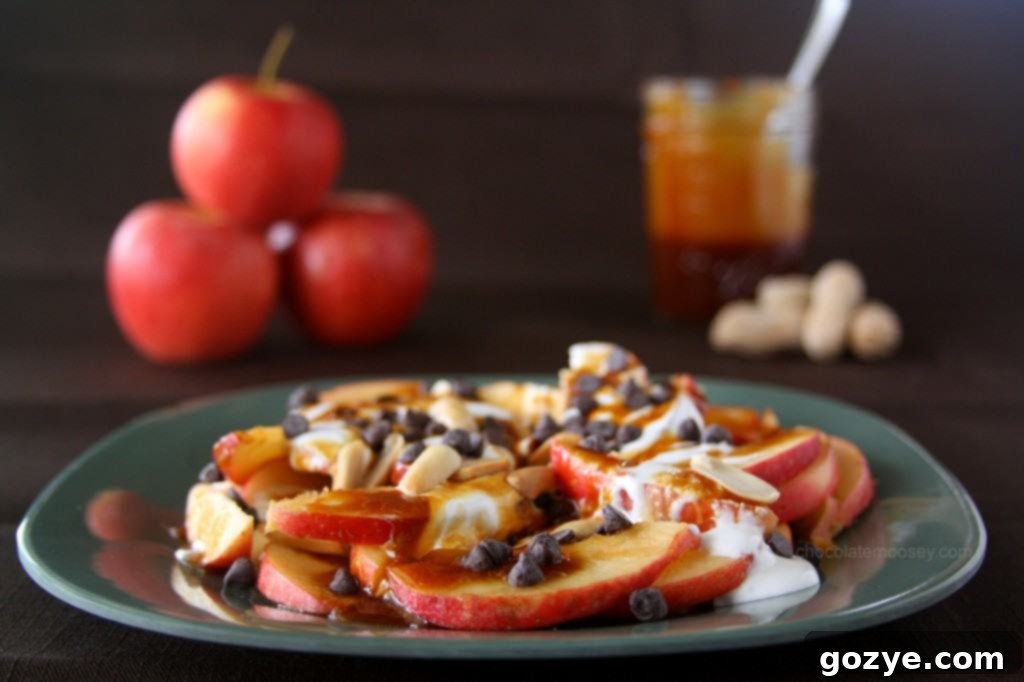 Delicious Apple Nachos - A sweet and easy treat Apple Nachos topped with caramel, marshmallow, chocolate, and peanuts
