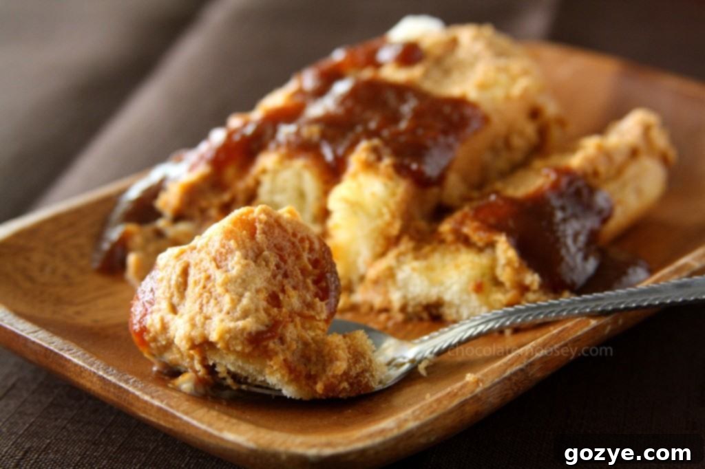 Close-up of a perfectly portioned slice of Pumpkin Tiramisu, showing the layers and a pool of caramel sauce.