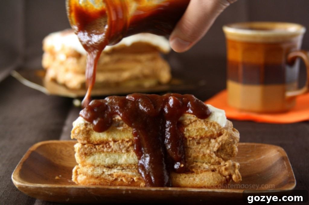 Spreading the spiced pumpkin cream layer over soaked ladyfingers in a Pumpkin Tiramisu.