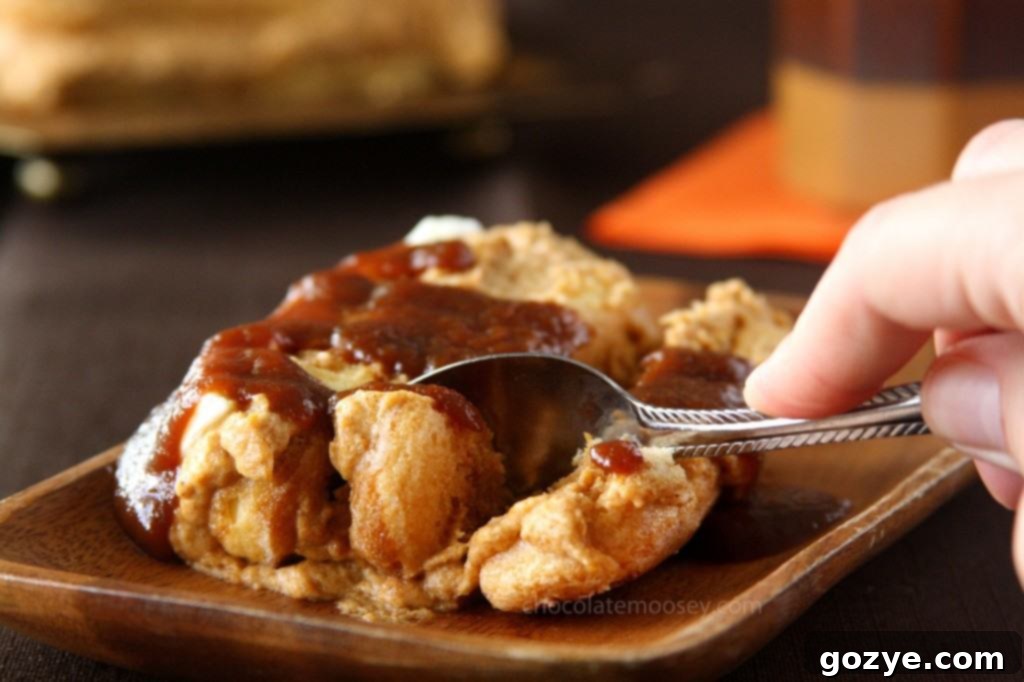 Homemade Pumpkin Butter Caramel Sauce being drizzled over a slice of Pumpkin Tiramisu.