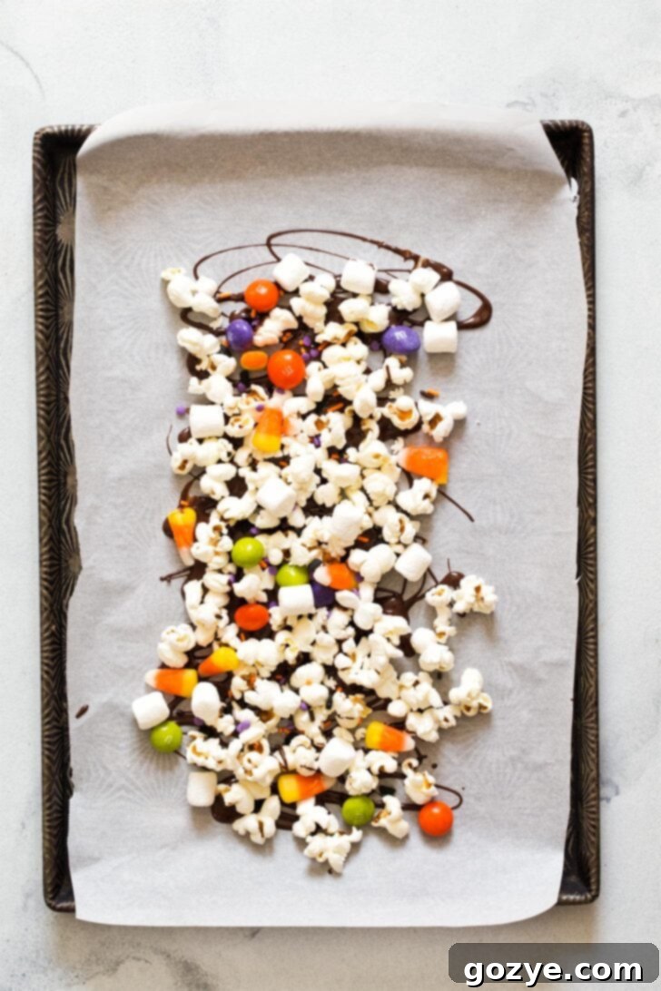 Assembling candy corn popcorn on baking tray
