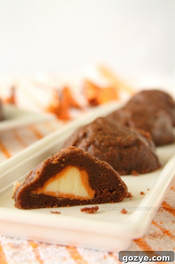 Stuffed Pumpkin Spice Kiss Cookies, showing the vibrant orange pumpkin spice center