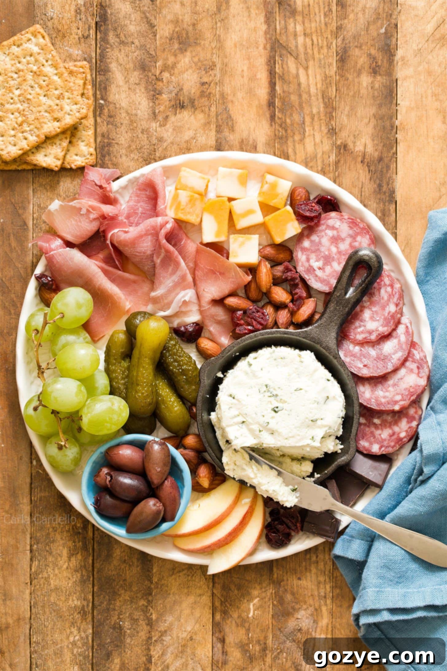 Beautifully arranged small charcuterie board for two on a white plate, perfect for date night or holiday entertaining