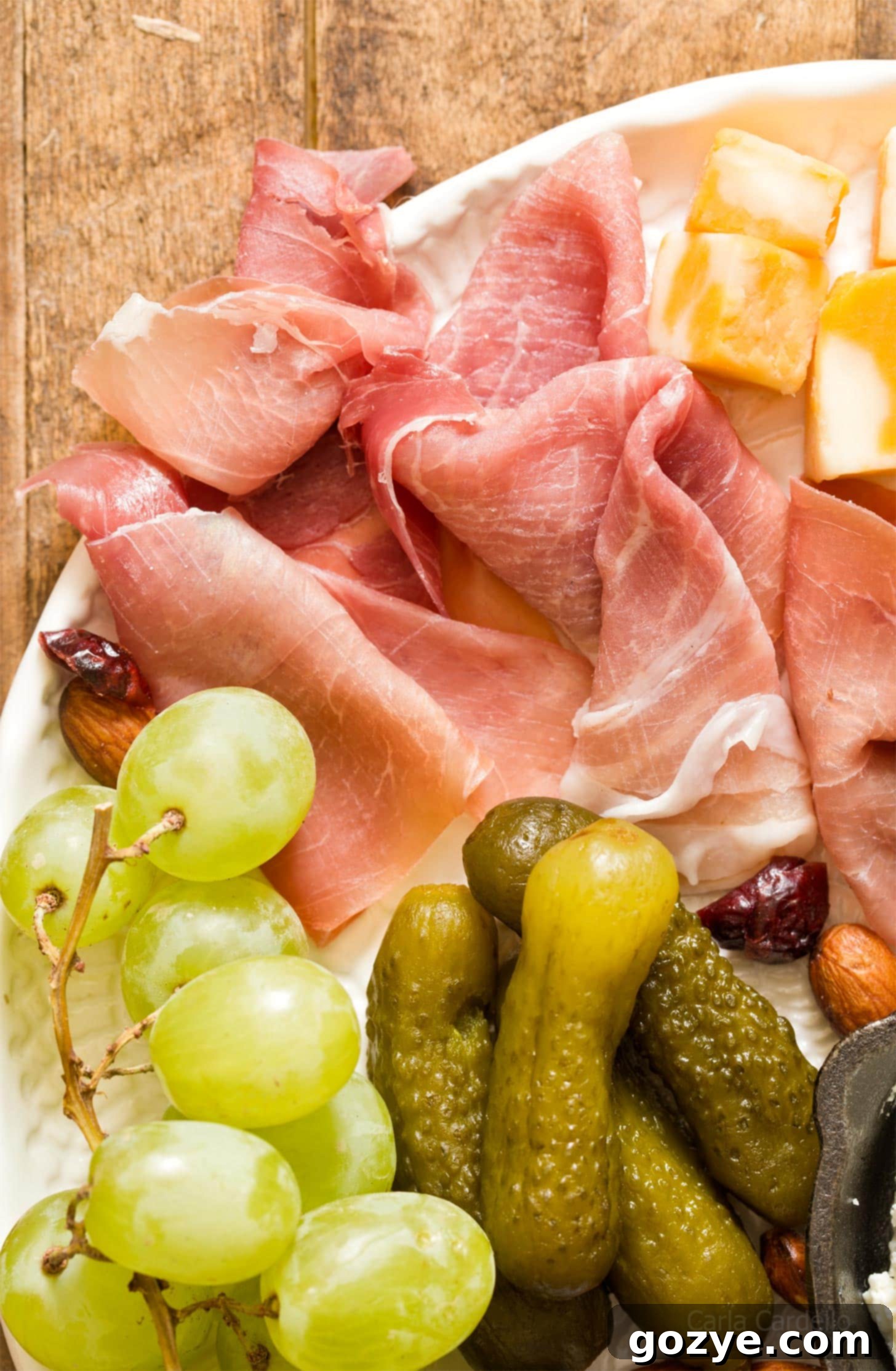 Close up of perfectly fanned slices of prosciutto on a charcuterie board