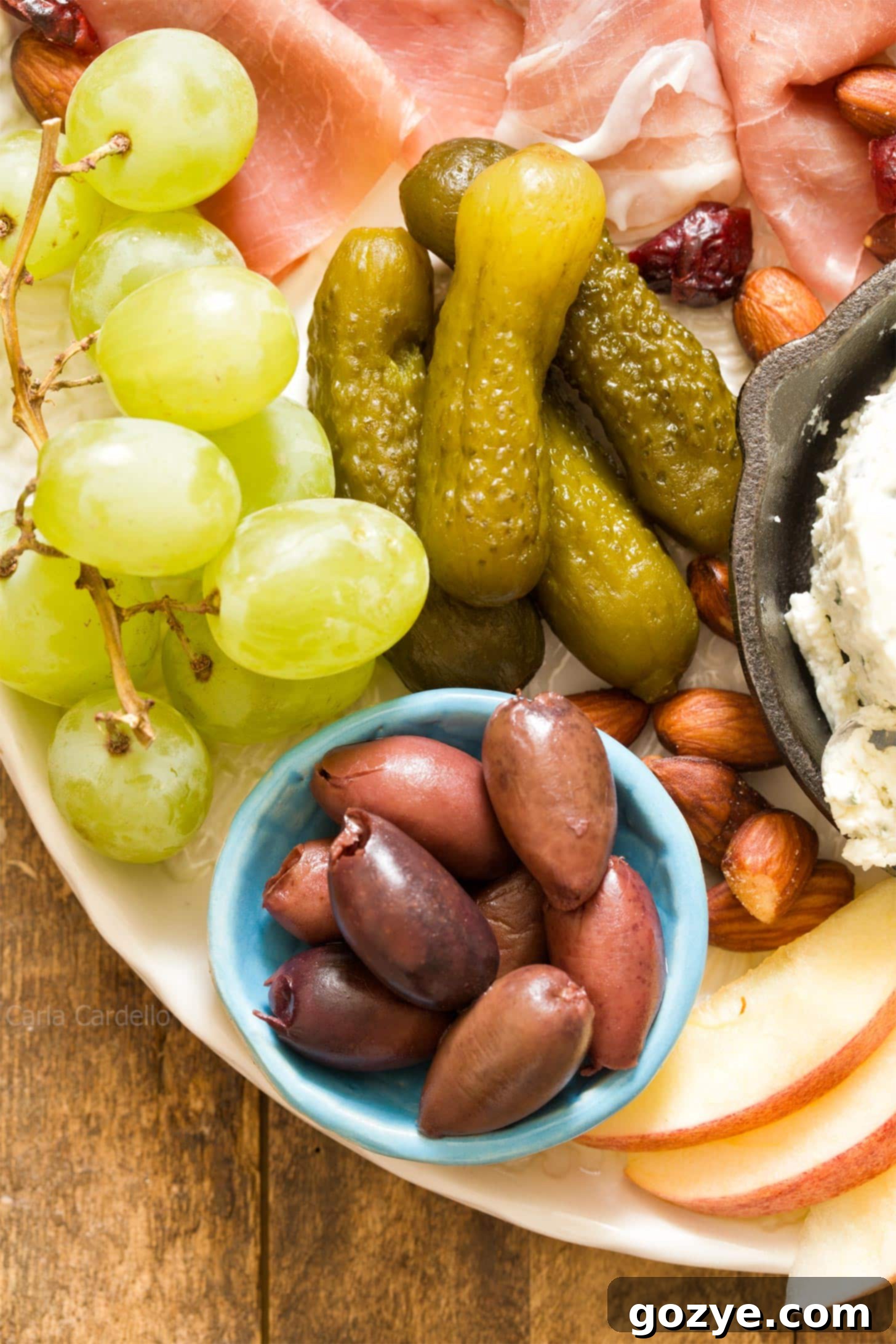 Close up of a selection of olives beautifully arranged on a small charcuterie board