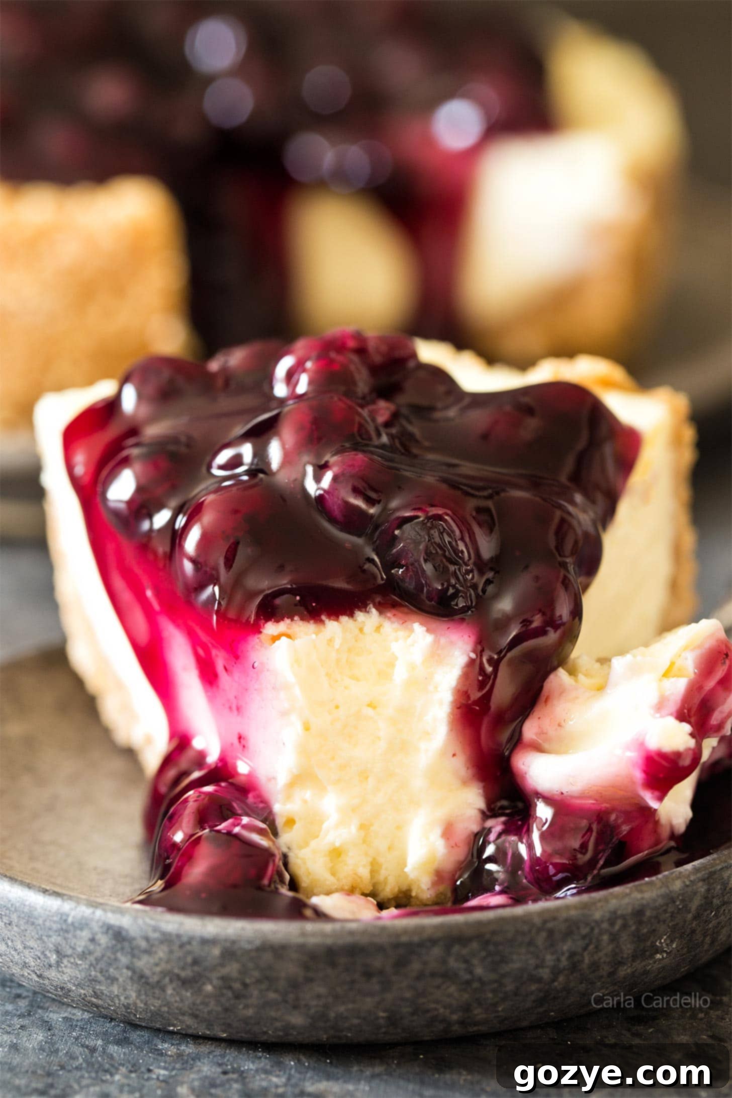 Delicious slice of 7 inch cheesecake topped with vibrant blueberry pie filling and a dollop of whipped cream