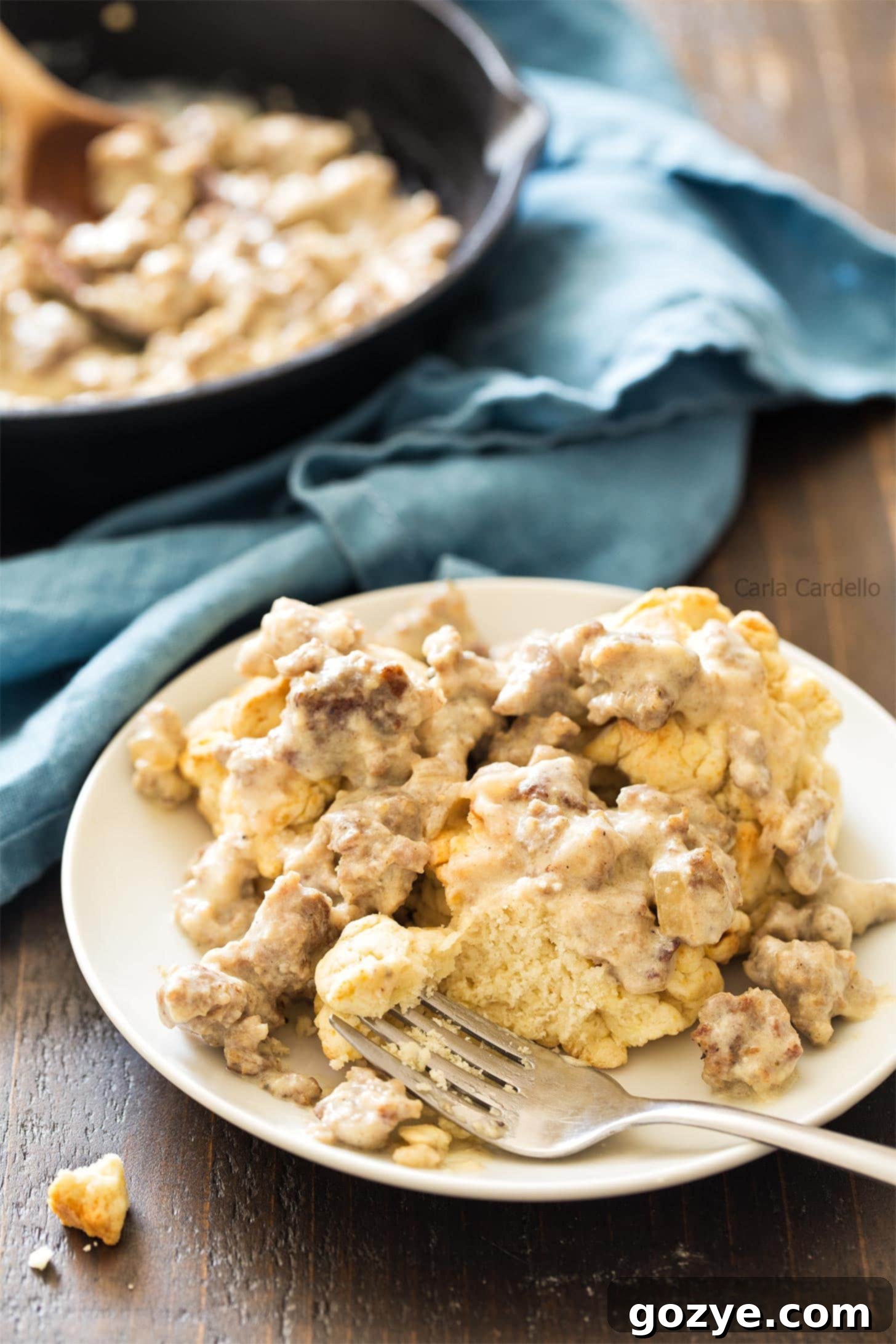Sausage gravy generously poured over fresh biscuits, ready to be served