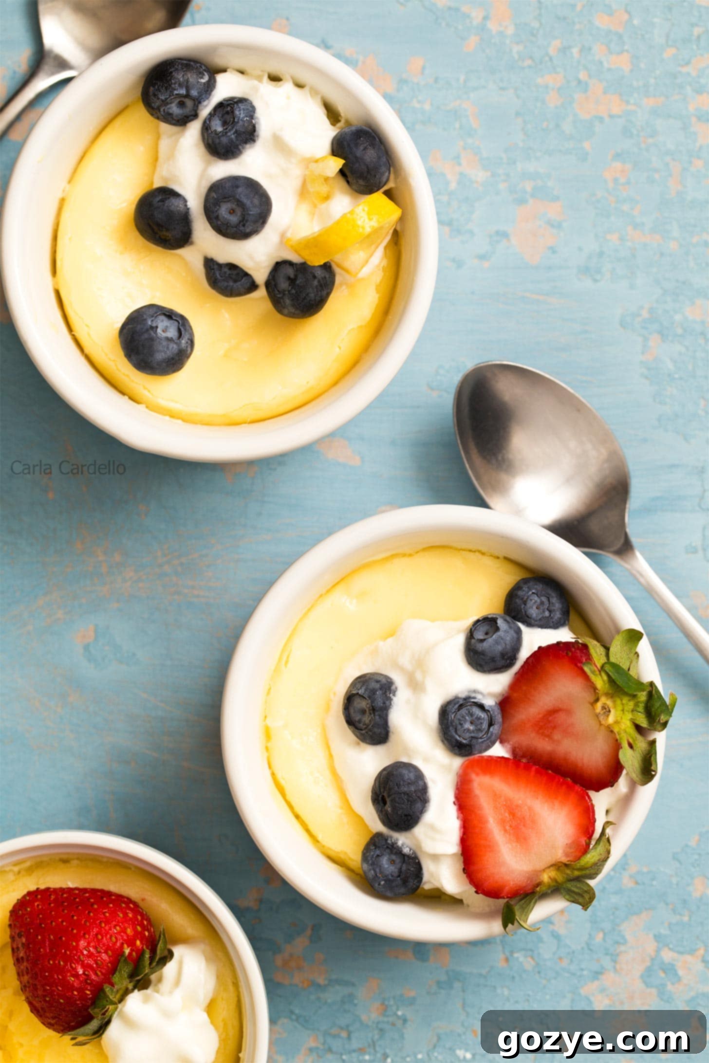 Air Fryer Cheesecake in ramekins with whipped cream and berries