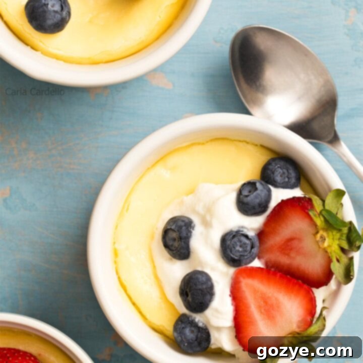 Air Fryer Cheesecake in ramekins with whipped cream and berries
