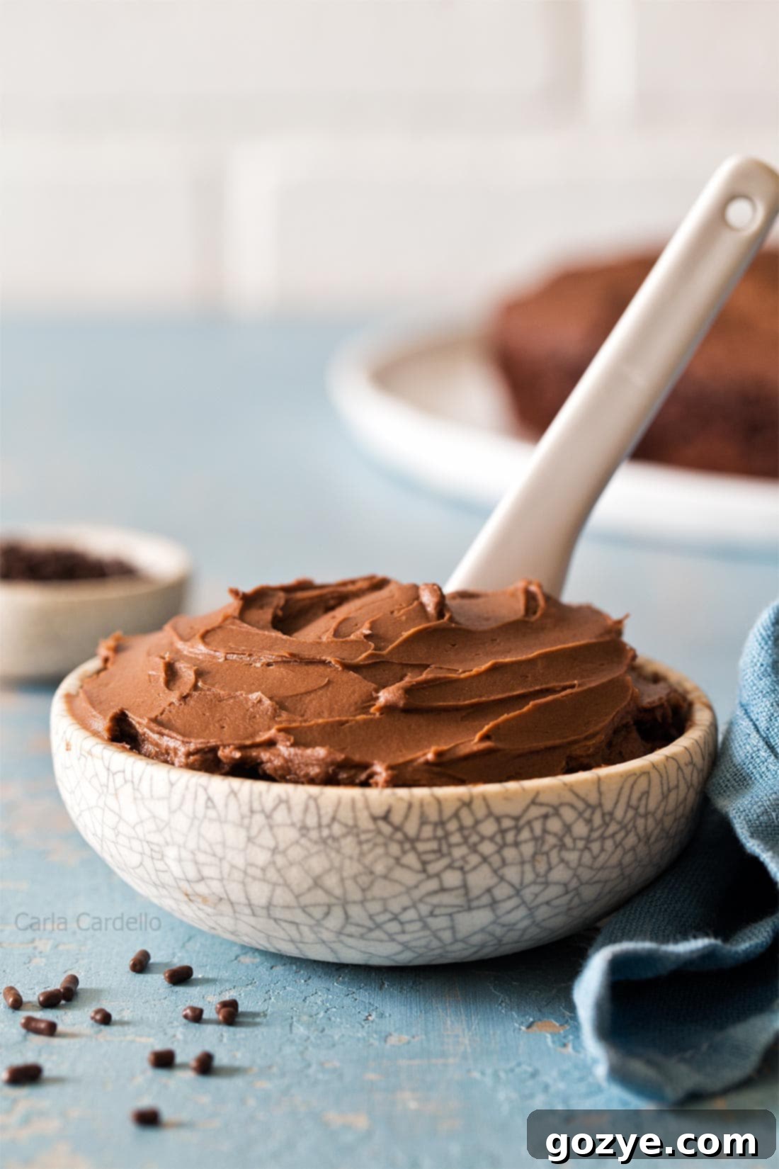 Chocolate Cream Cheese Frosting with white knife in small bowl