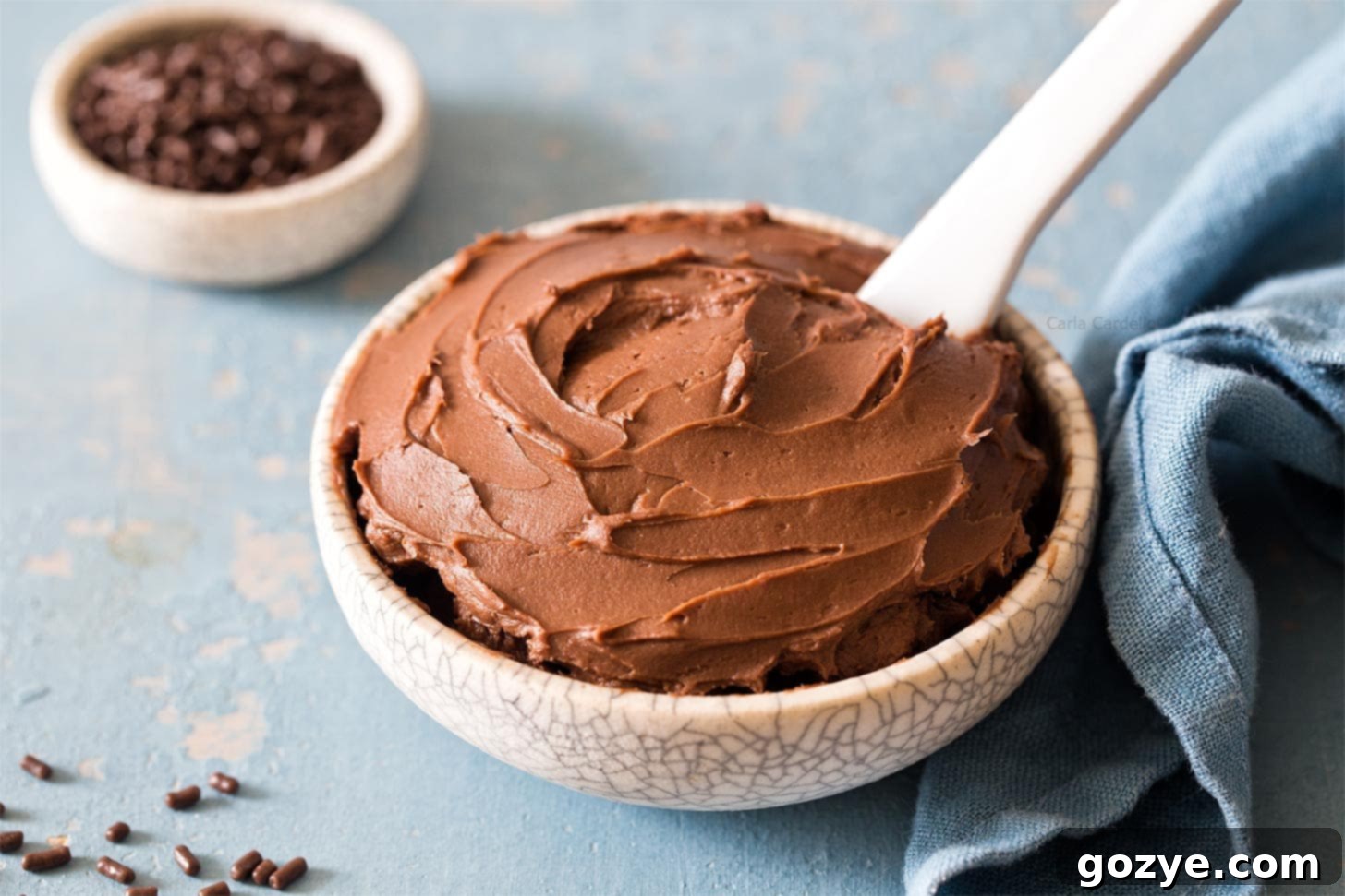 Cream Cheese Chocolate Frosting in small bowl with white knife