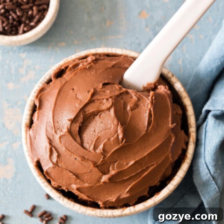 Cream Cheese Chocolate Frosting in small bowl with white knife