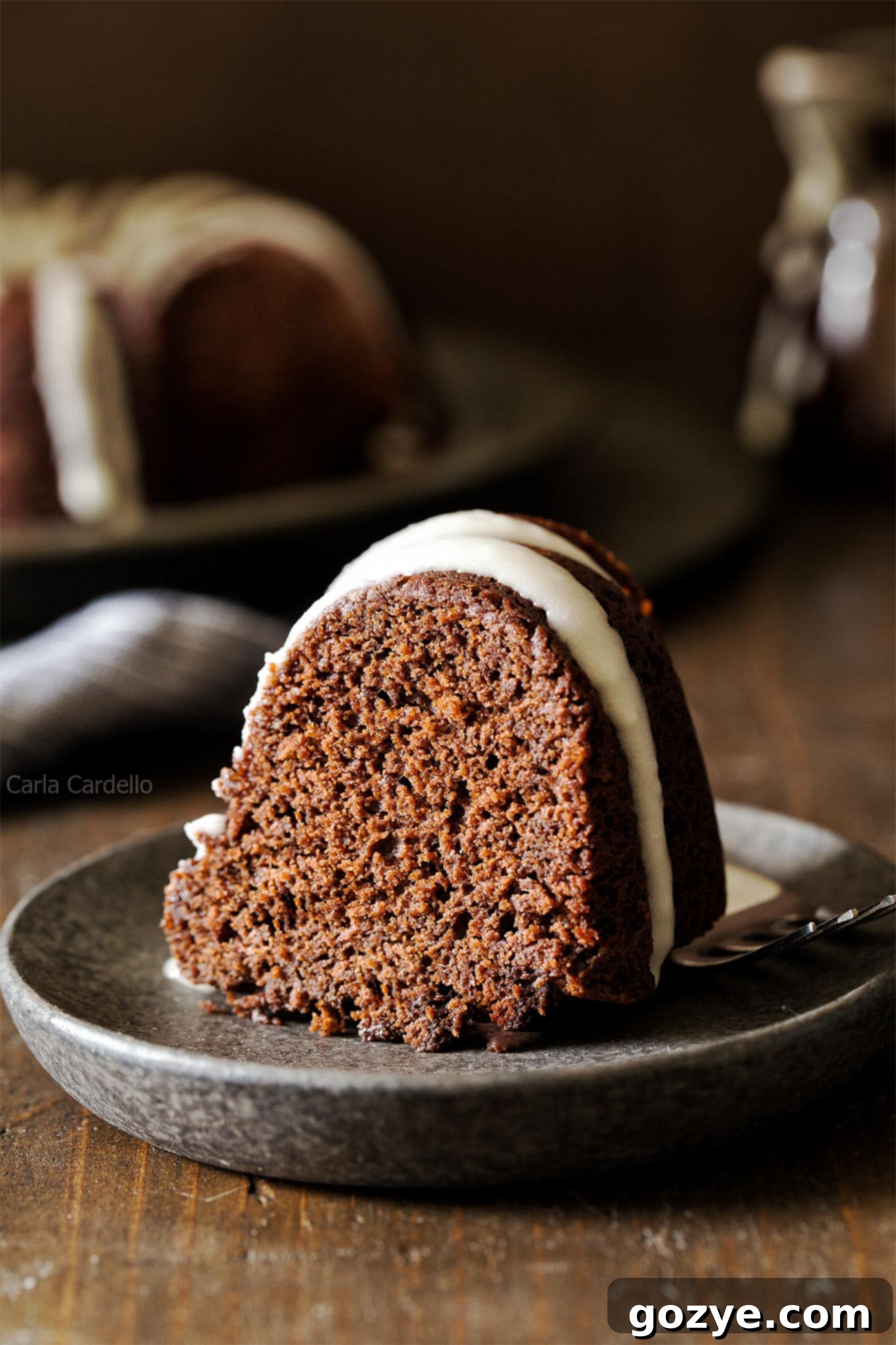 Slice of small chocolate bundt cake with glaze