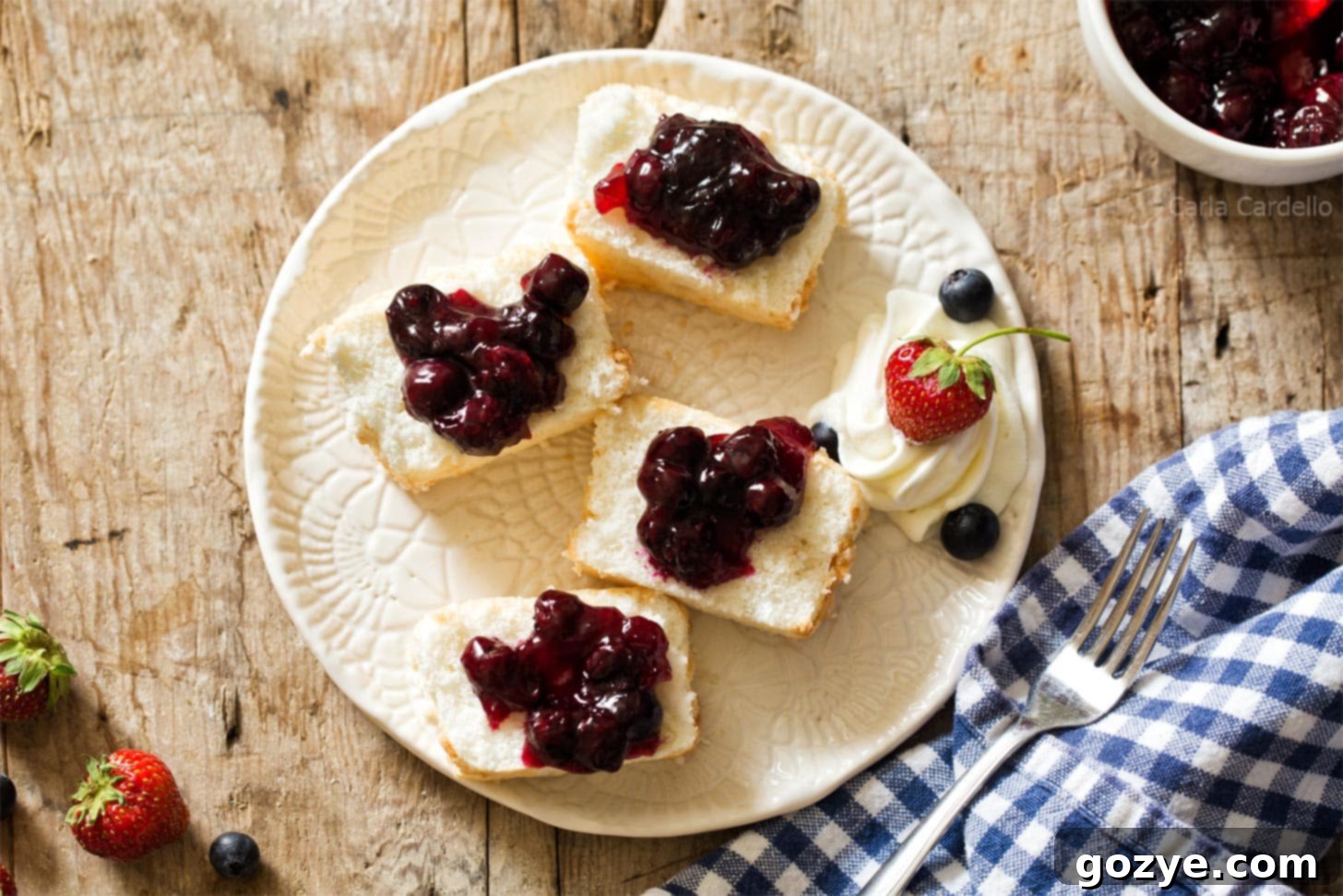Slices of angel food cake with blueberry pie filling
