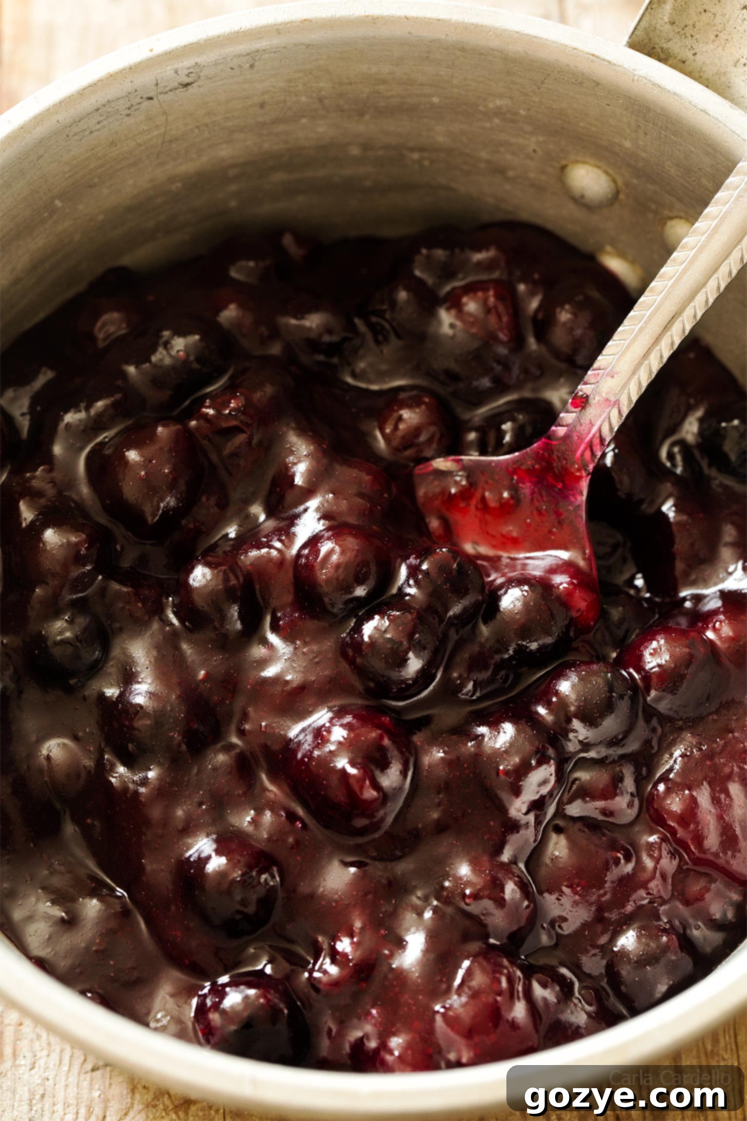 Close up view of the homemade blueberry pie filling bubbling gently in a saucepan, showing the thickened texture