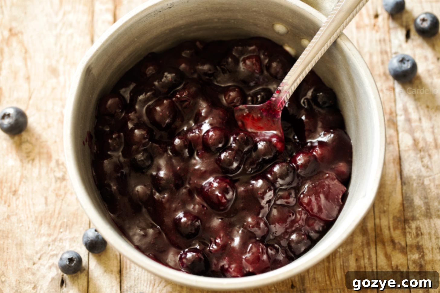 Ingredients for blueberry pie filling, including fresh blueberries, sugar, cornstarch, and lemon