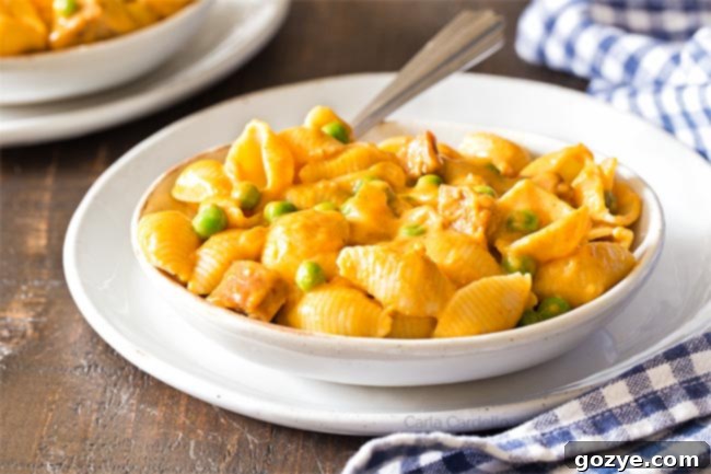 A bowl of pumpkin macaroni and cheese, showcasing its vibrant orange color and creamy texture.