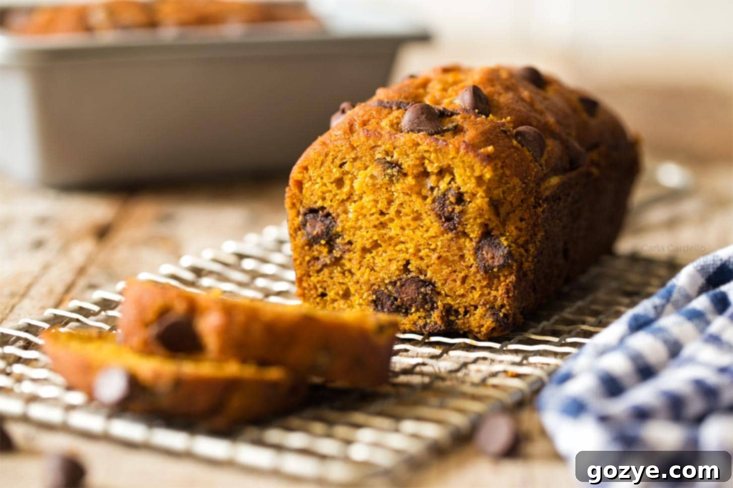 Close up of a mini pumpkin bread loaf, showing its golden crust.