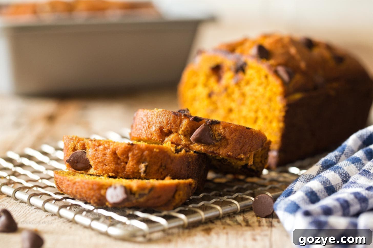 Close up of slices of pumpkin bread, highlighting the golden color and soft interior.