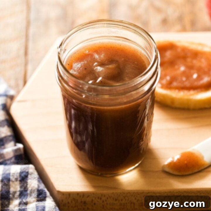 Jar of apple butter, with warm, inviting autumn tones.