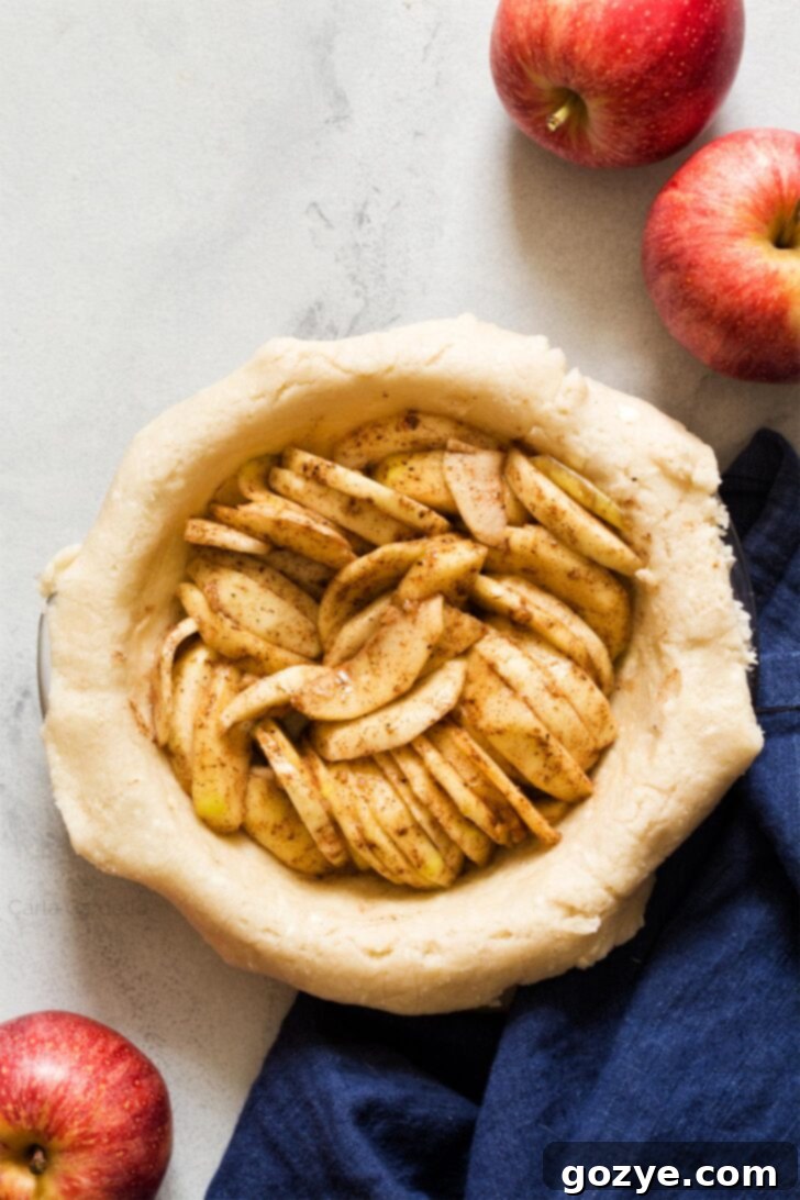 Freshly sliced apples tossed with sugar and spices, ready for the pie filling.