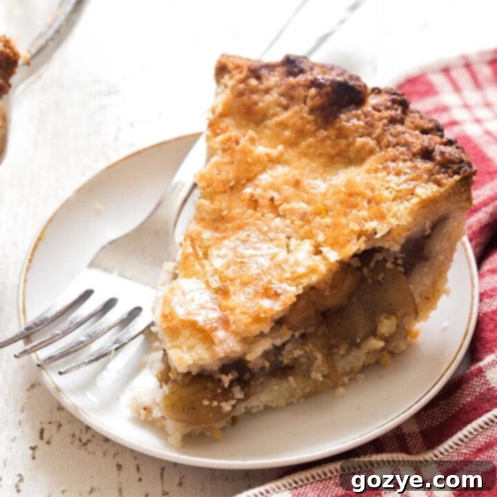 Slice of 6 inch apple pie, beautifully baked with golden crust and visible apple filling.