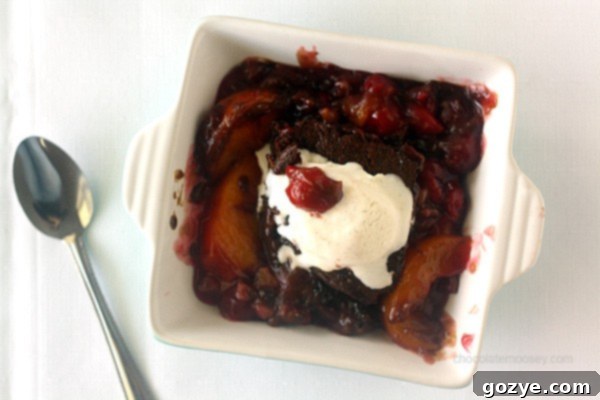 Close-up of the spiced gingerbread topping on Peach and Cherry Cobbler, showing its cake-like texture.