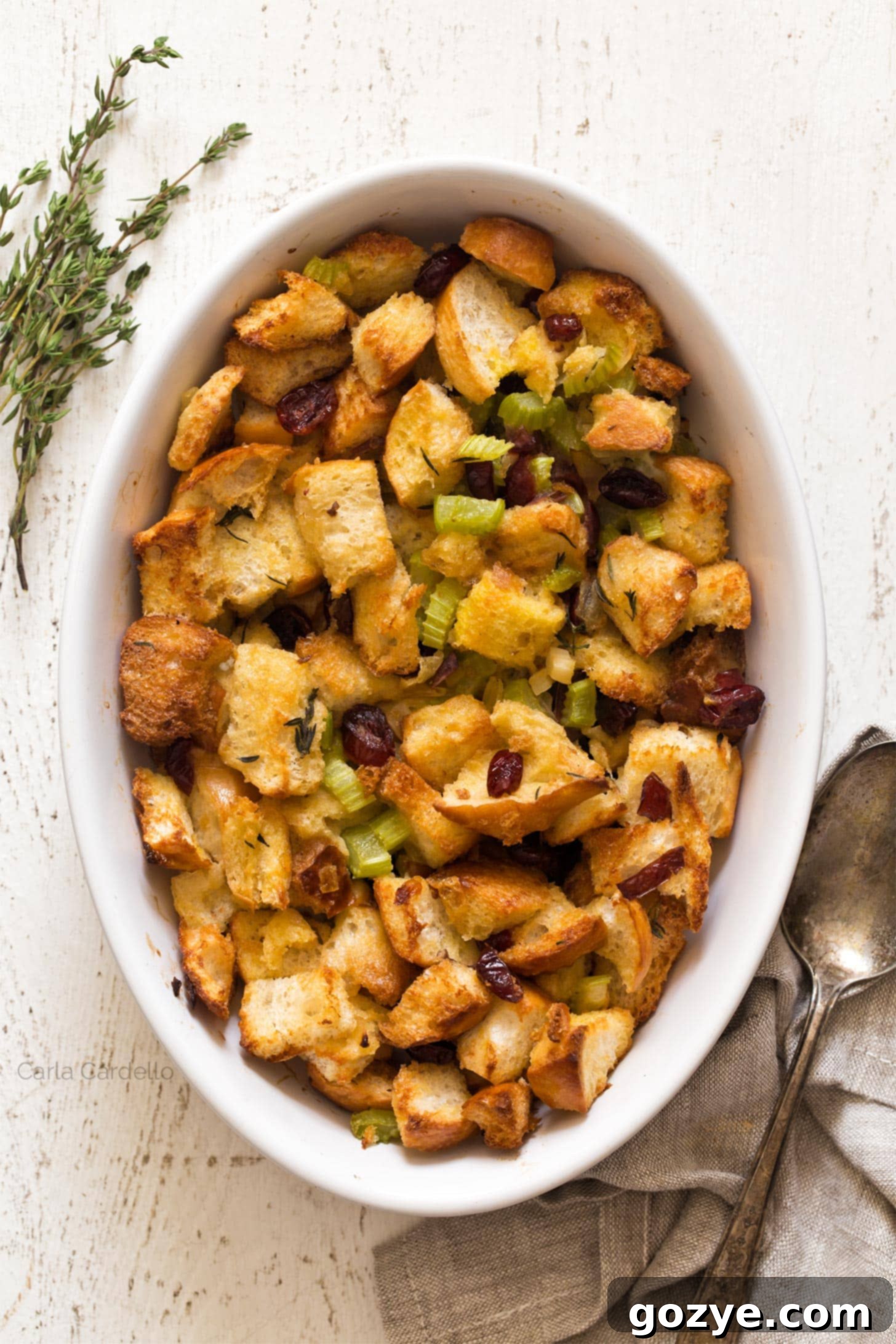 Golden brown cranberry stuffing in a casserole dish, ready to be served for Thanksgiving