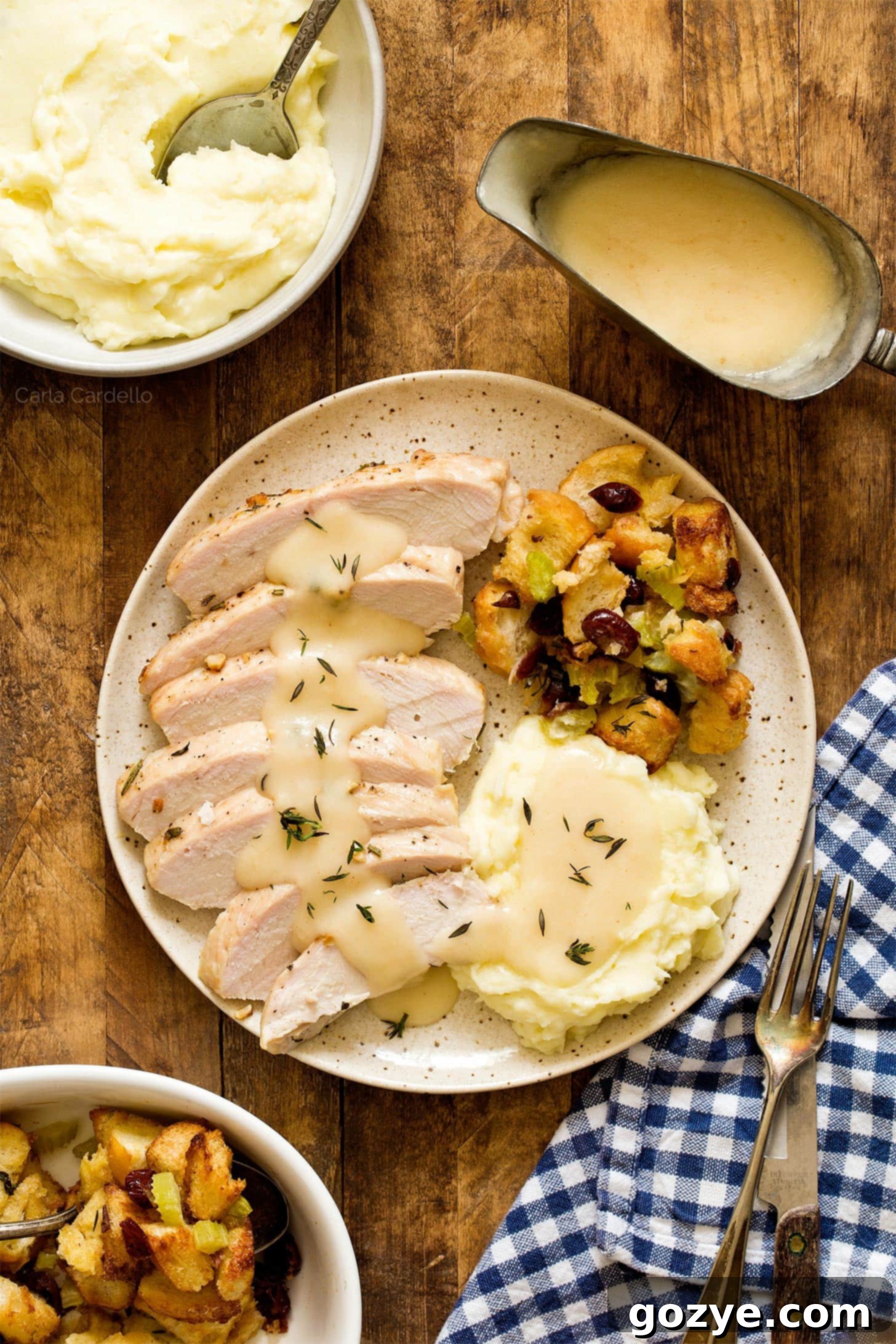 Herb-roasted turkey tenderloin served with mashed potatoes, turkey gravy, and stuffing