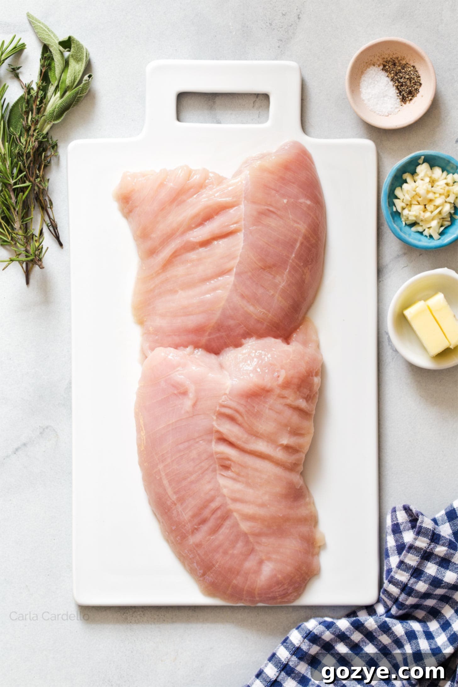 Raw turkey tenderloin on a wooden cutting board