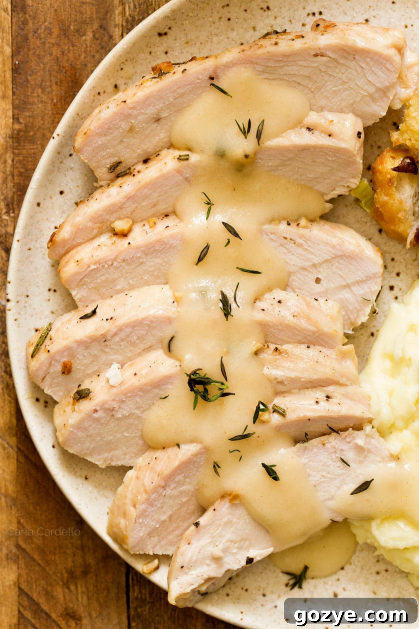 Platter of sliced turkey breast tenderloin with homemade turkey gravy drizzled on top