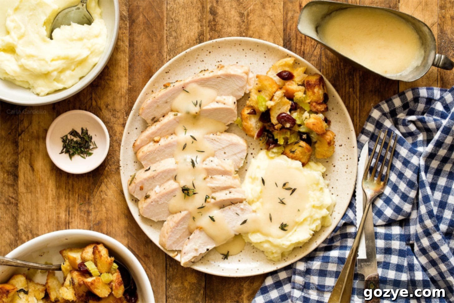Small Thanksgiving dinner with sliced turkey tenderloin, cranberry stuffing, creamy mashed potatoes, and rich turkey gravy