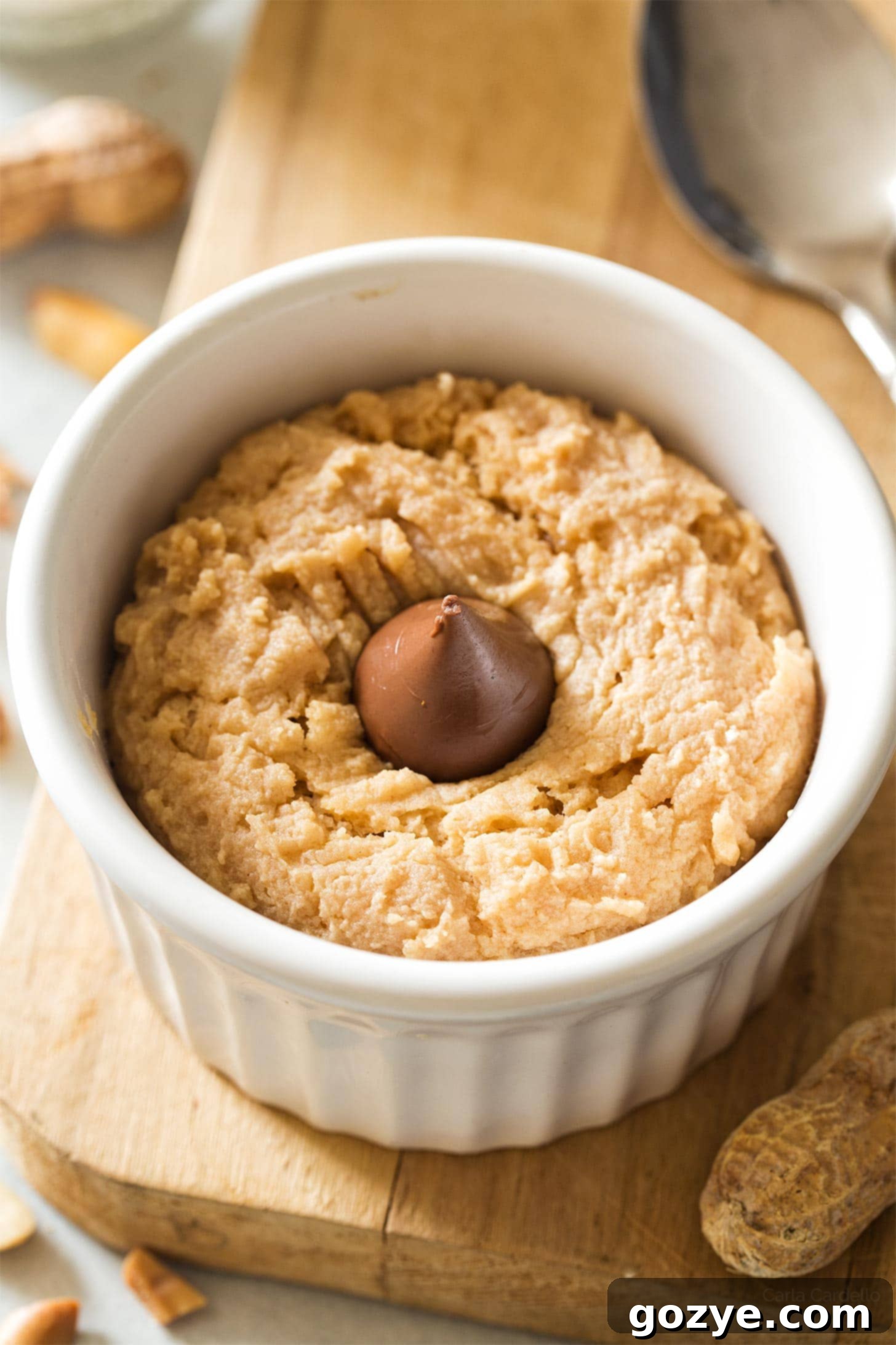 Close-up of a perfectly cooked microwave peanut butter cookie, showing its rich, golden-brown crust and inviting texture, ready to be eaten.