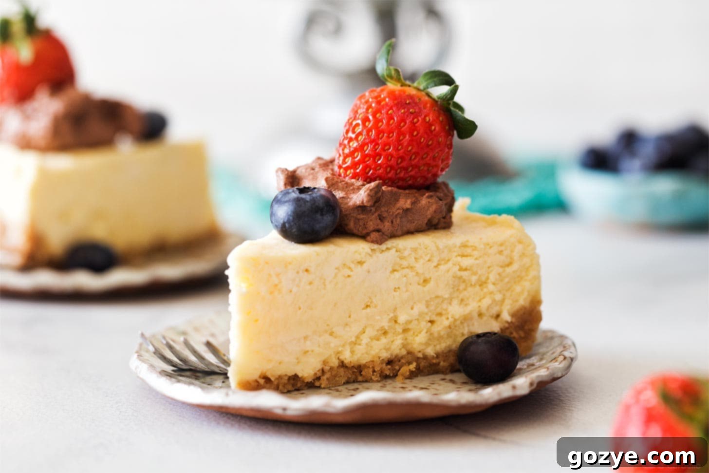 A perfect slice of Instant Pot Cheesecake on a white plate.