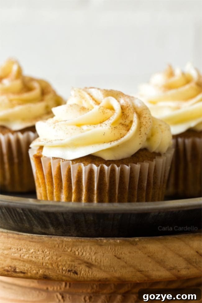 Close up of a perfectly baked pumpkin cupcake, showcasing its moist texture and inviting color.