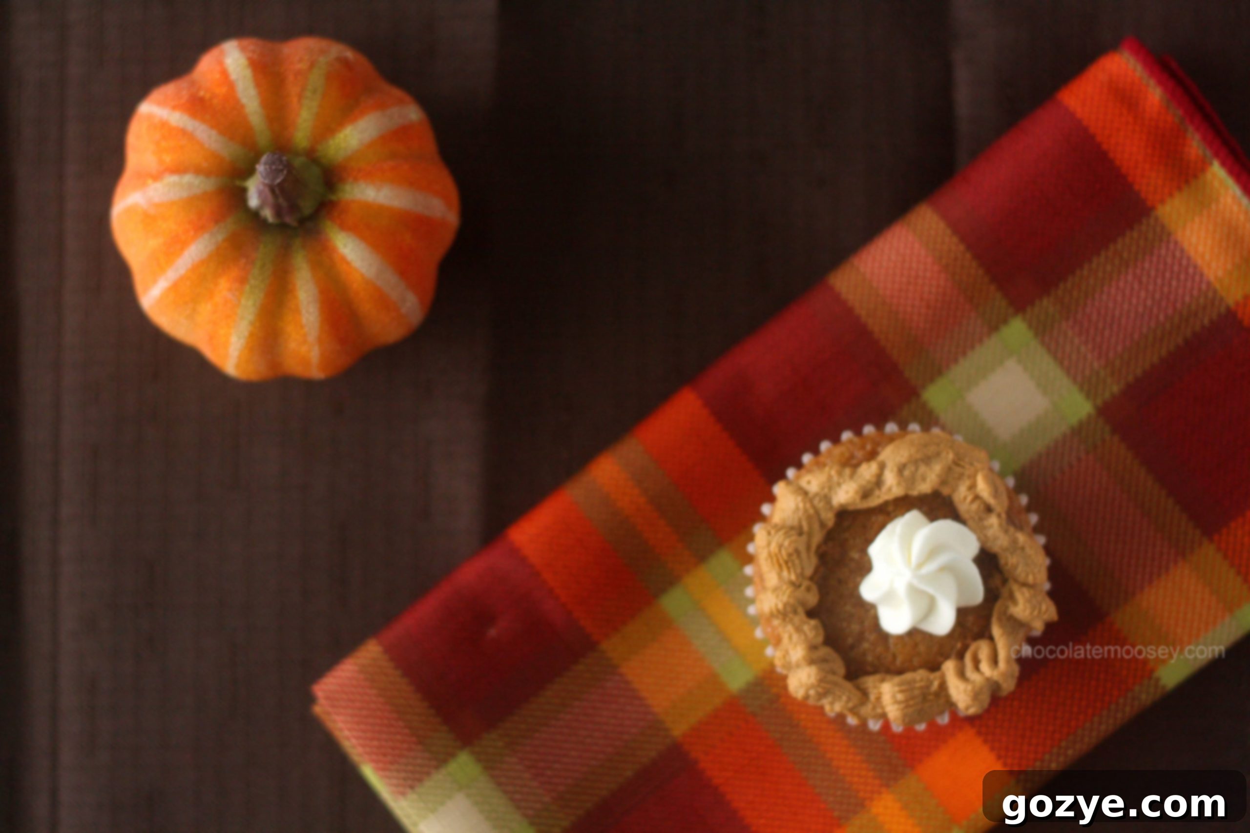 Overhead shot of a pumpkin pie cupcake, beautifully frosted and ready to be enjoyed.
