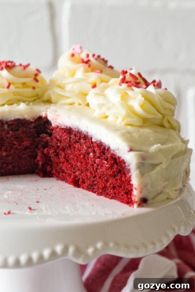 A small 6-inch red velvet cake with cream cheese frosting.