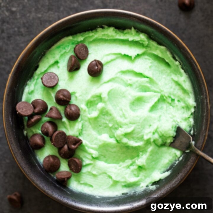 Mint Frosting in a bowl with spatula, ready for piping.